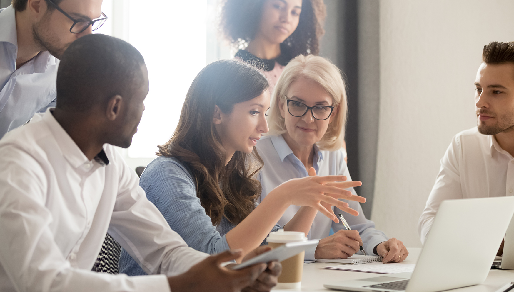 a group of people sitting around a table
