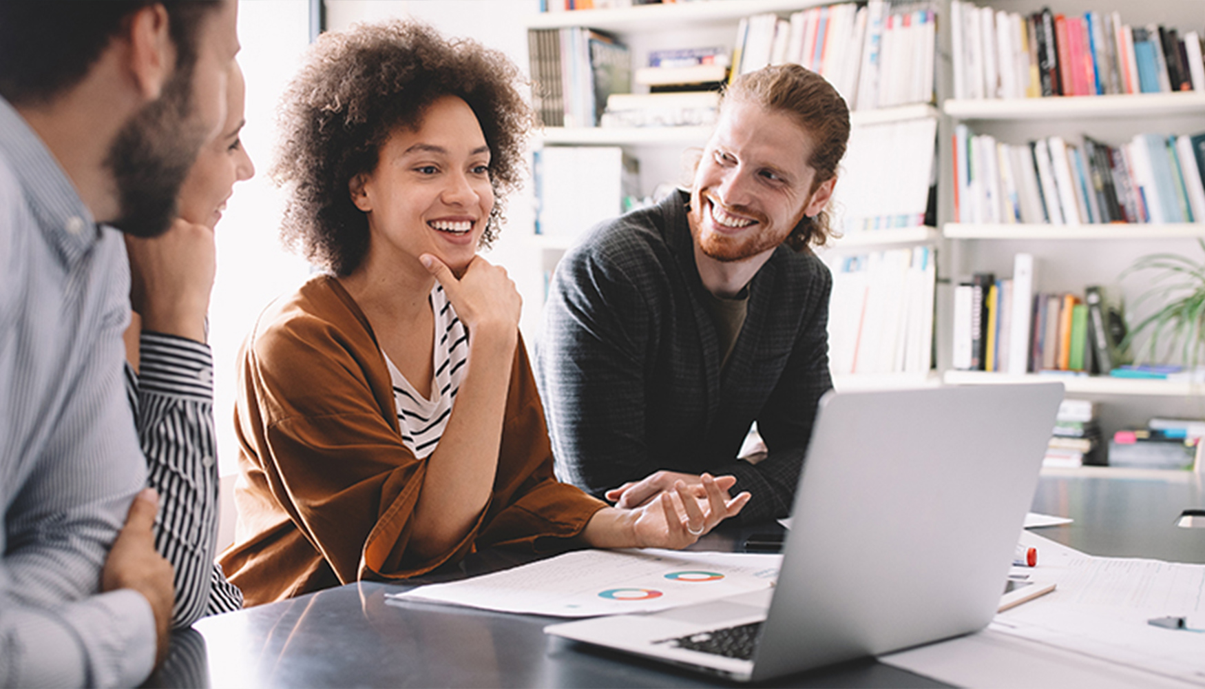 a man and woman looking at a laptop