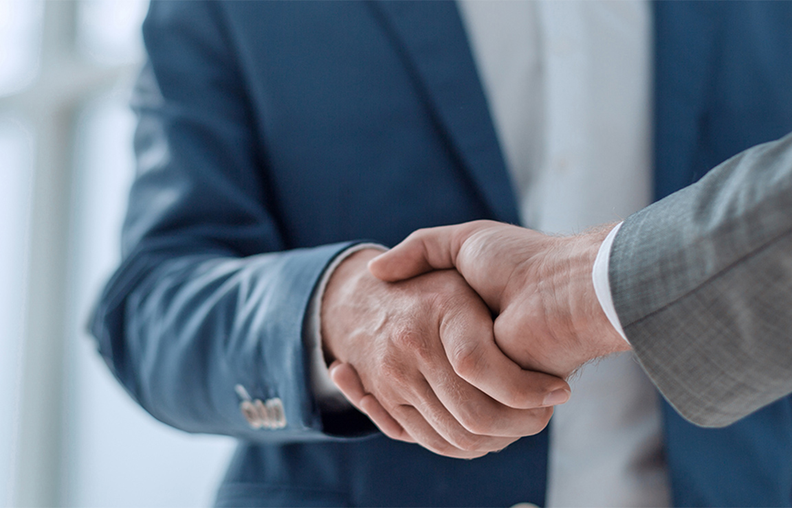 a close-up of a man shaking hands