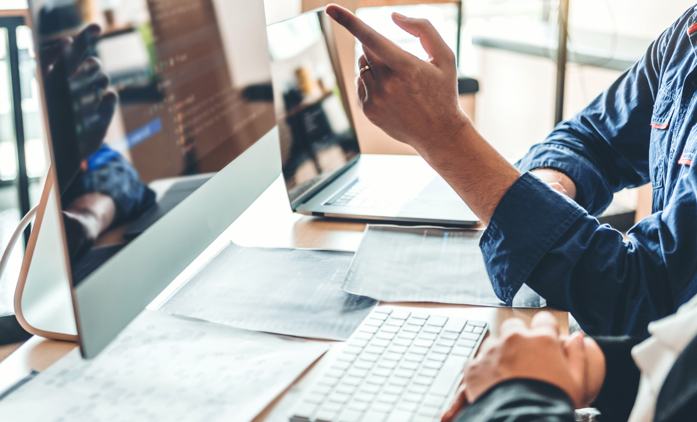 a person pointing at a computer screen