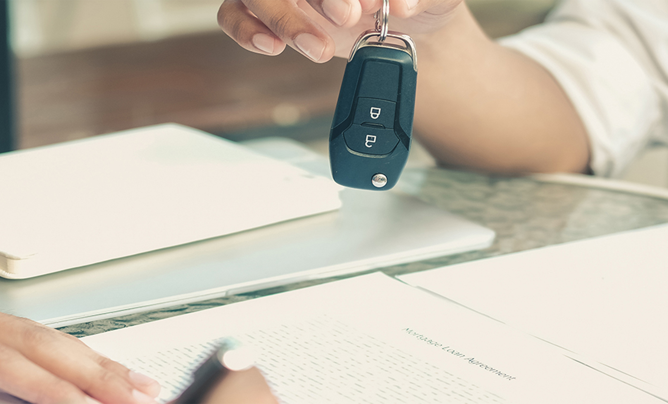 a person holding a car key