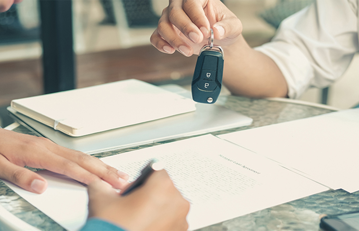 a person holding a car key