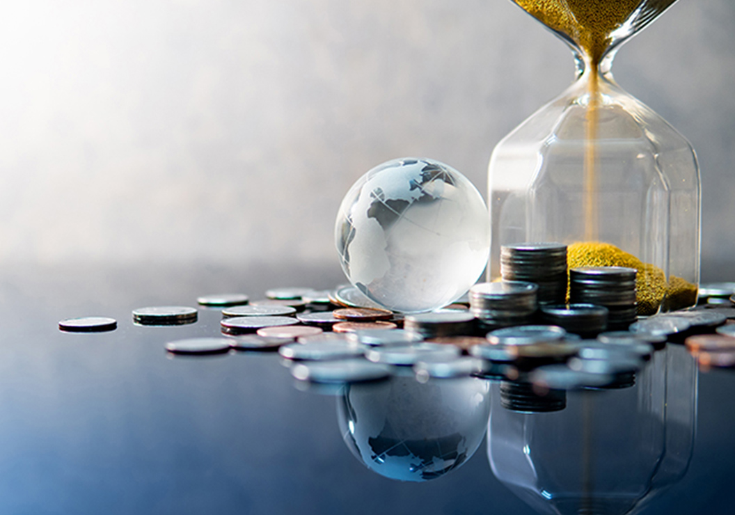 a glass globe and coins on a table