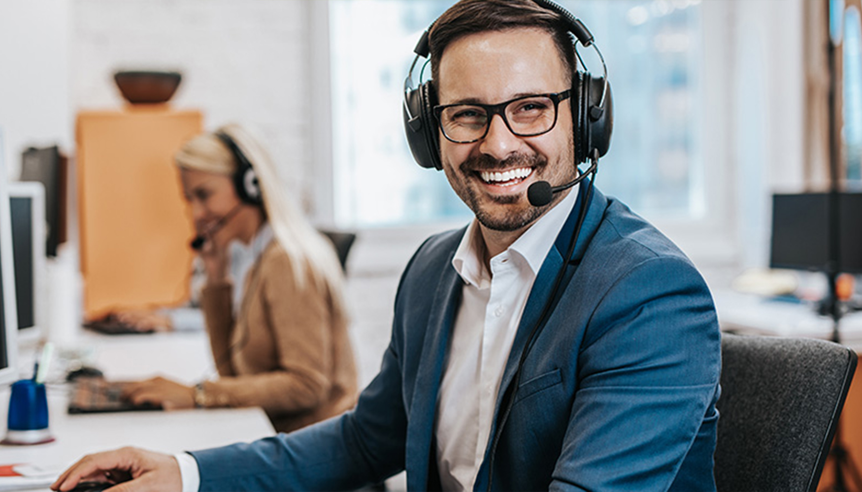 a man wearing a headset and smiling