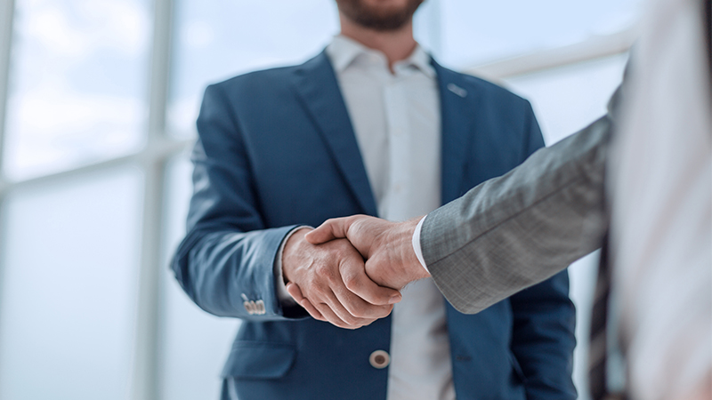 a close-up of a man shaking hands