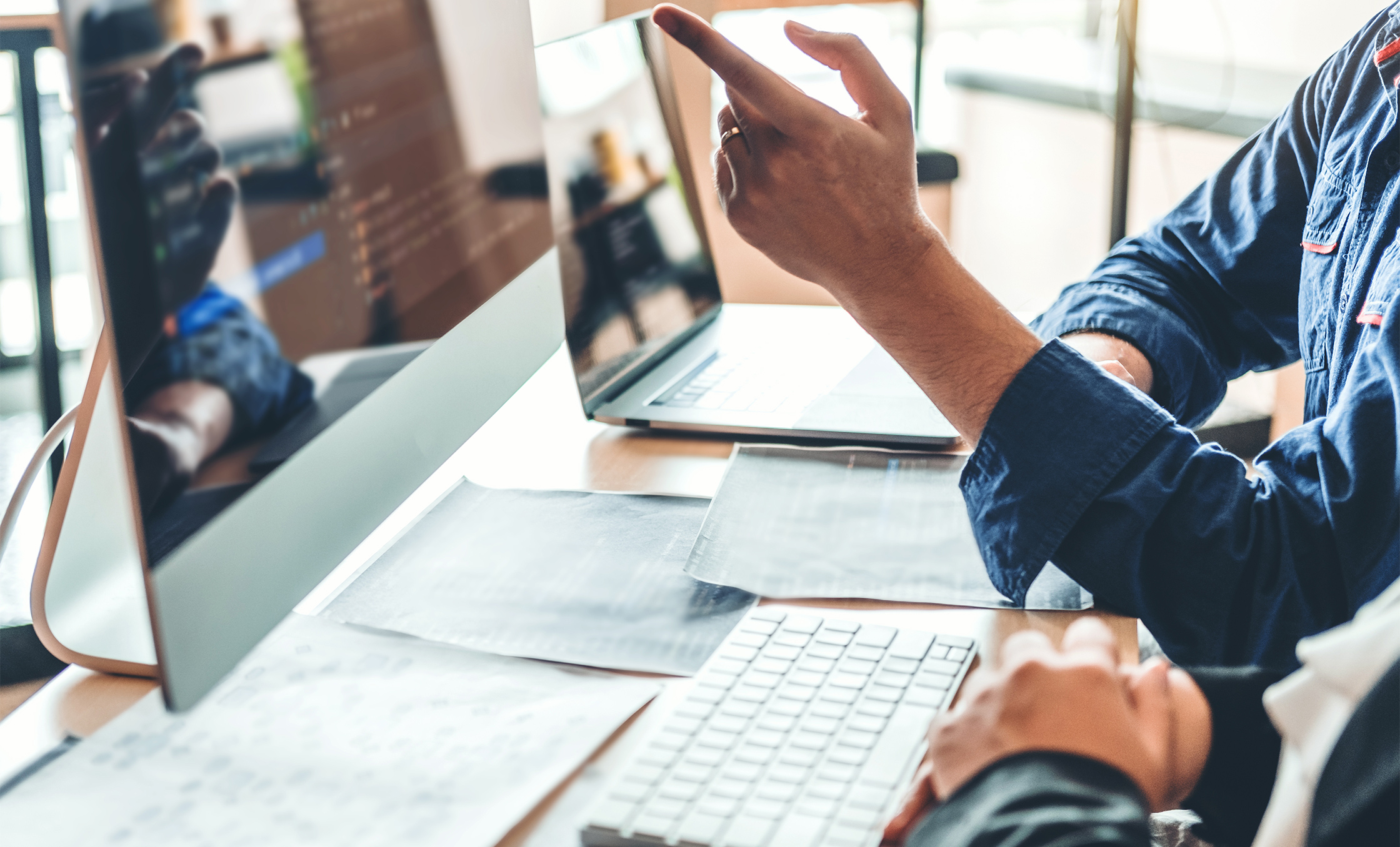 a person pointing at a computer screen