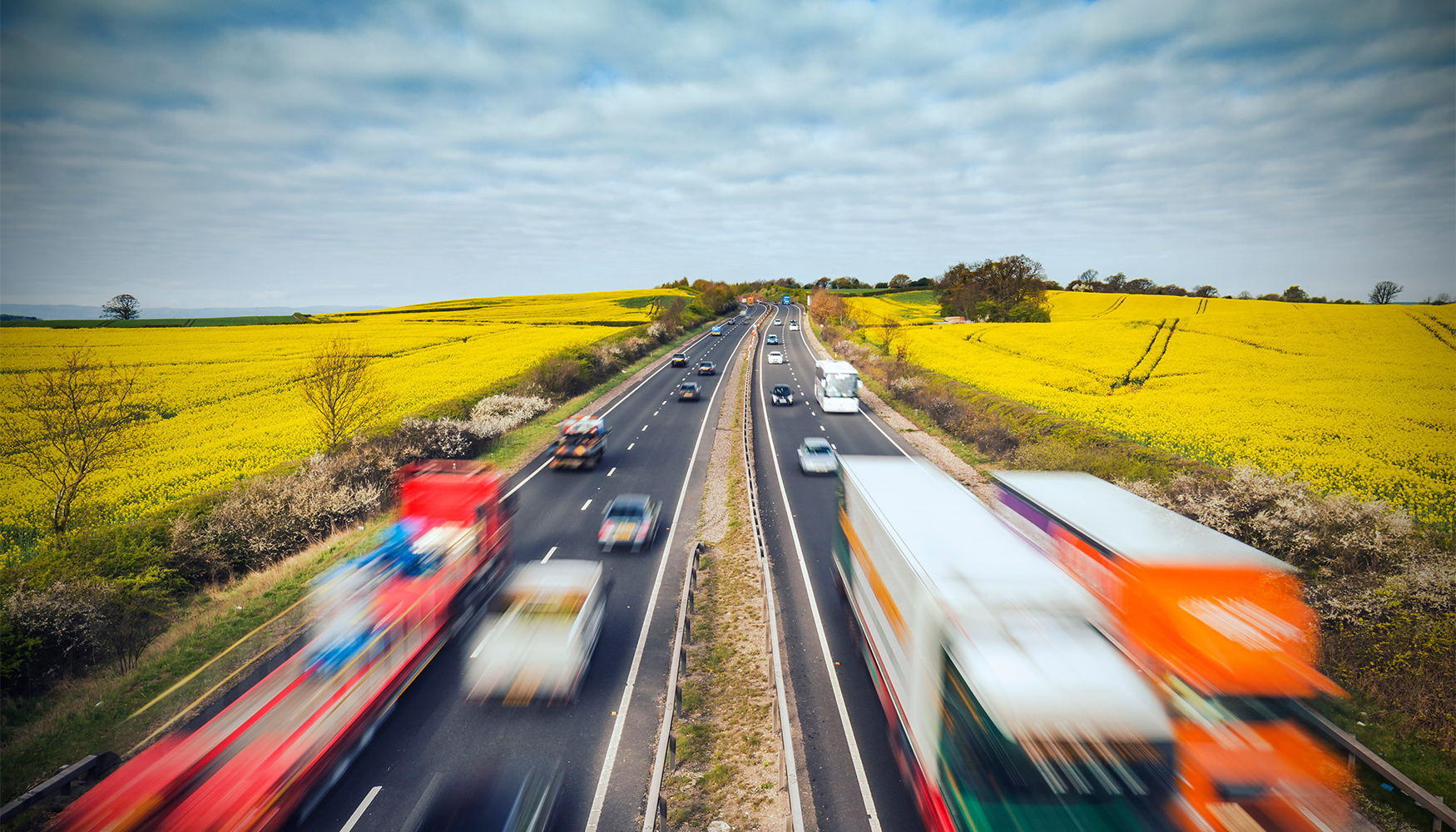 a highway with cars and trucks on it