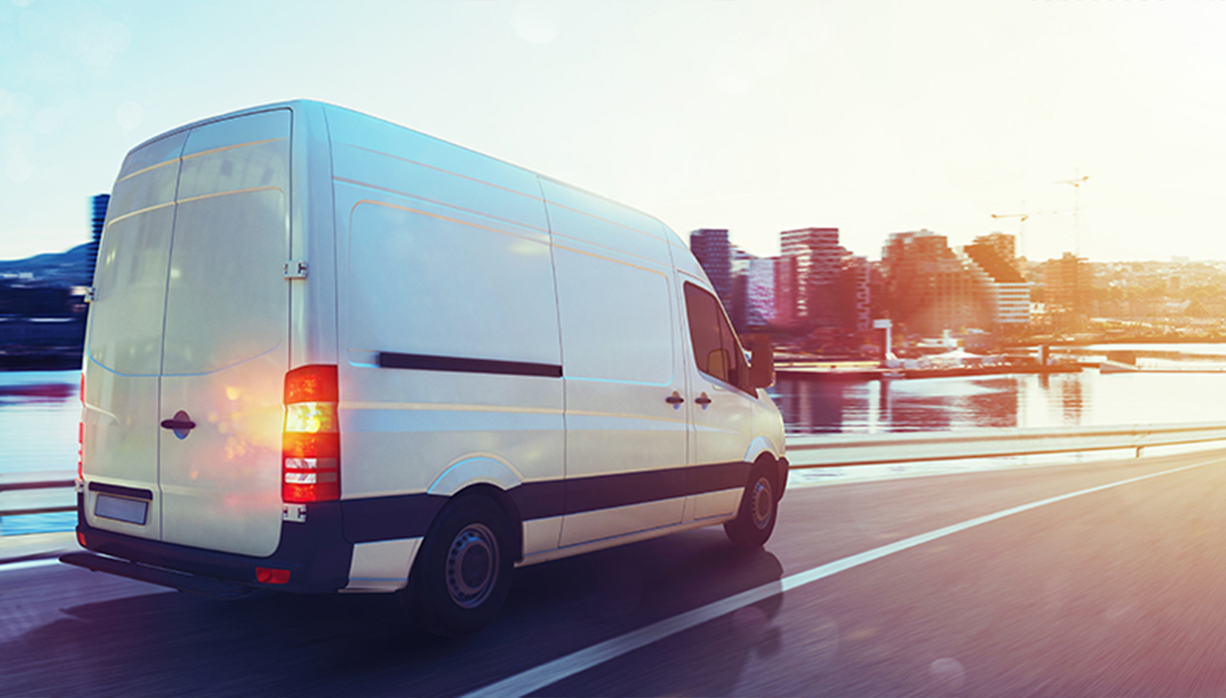 a white van driving on a road