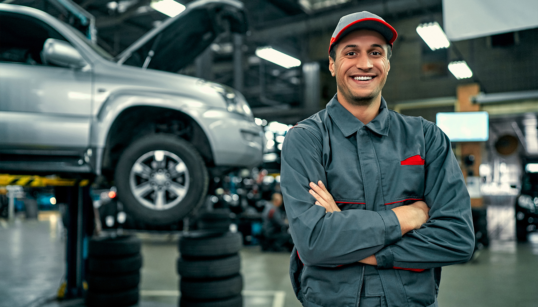 a man in a uniform standing in front of a car