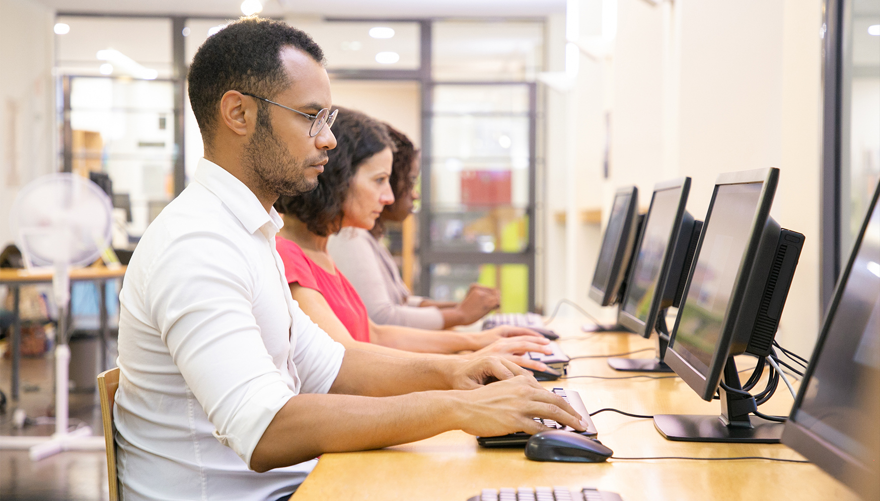 a group of people sitting at computers