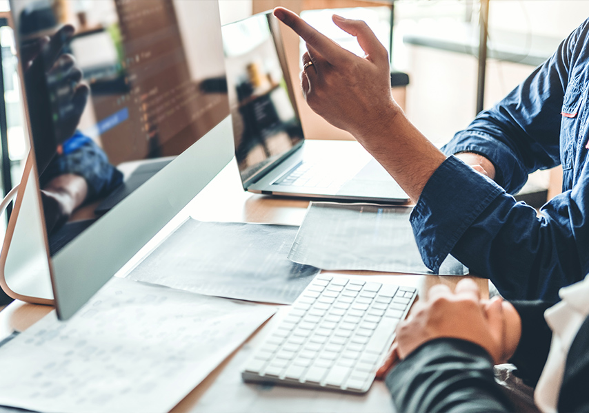 a man pointing at a computer screen