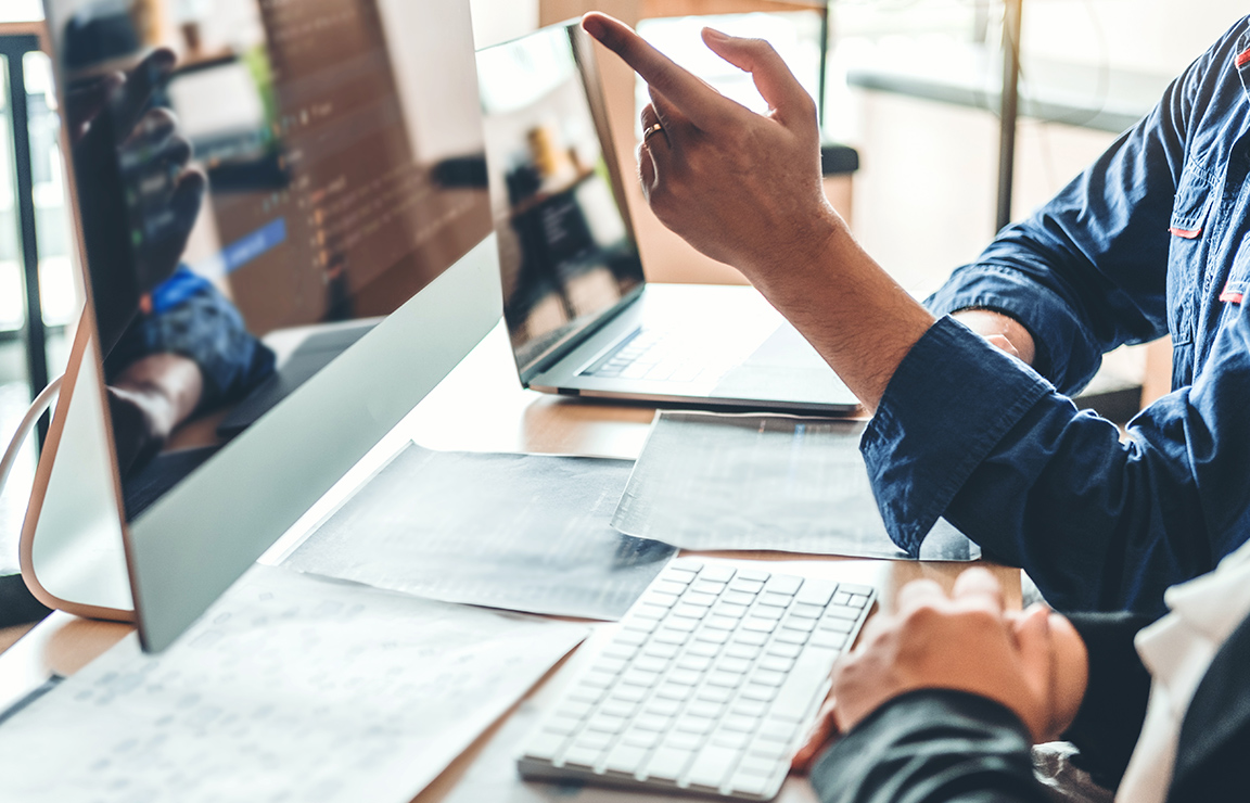 a man pointing at a computer screen