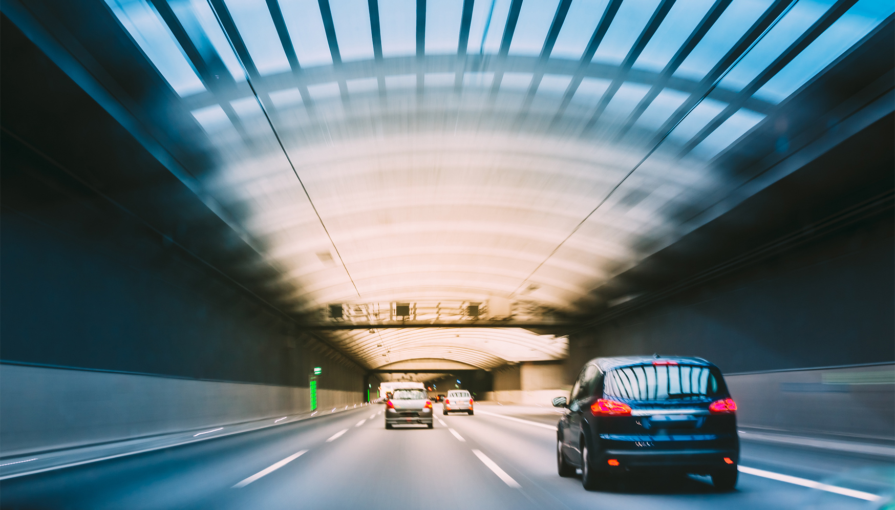 cars driving through a tunnel