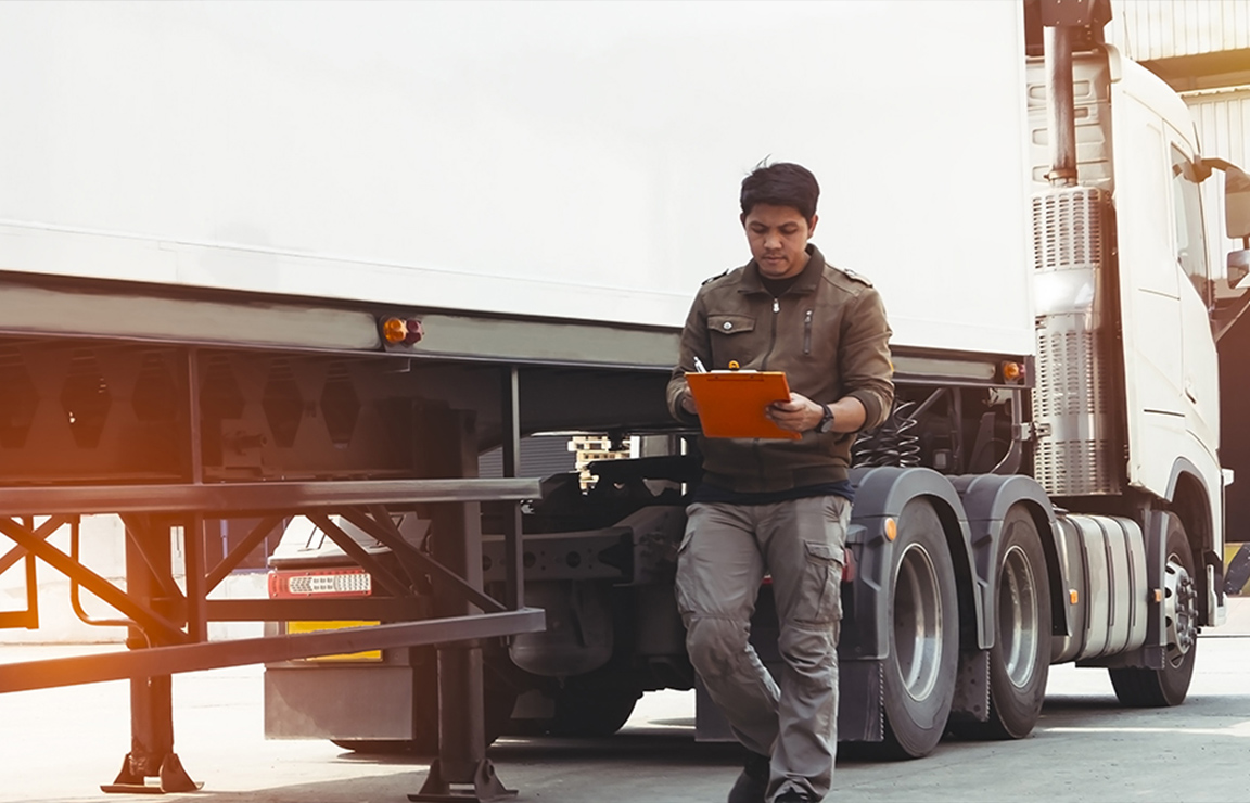 a man standing next to a truck