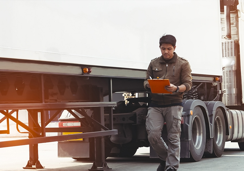 a man standing next to a truck