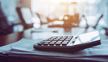 A calculator on top of papers