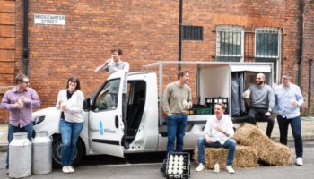 People sitting around an electric delivery truck