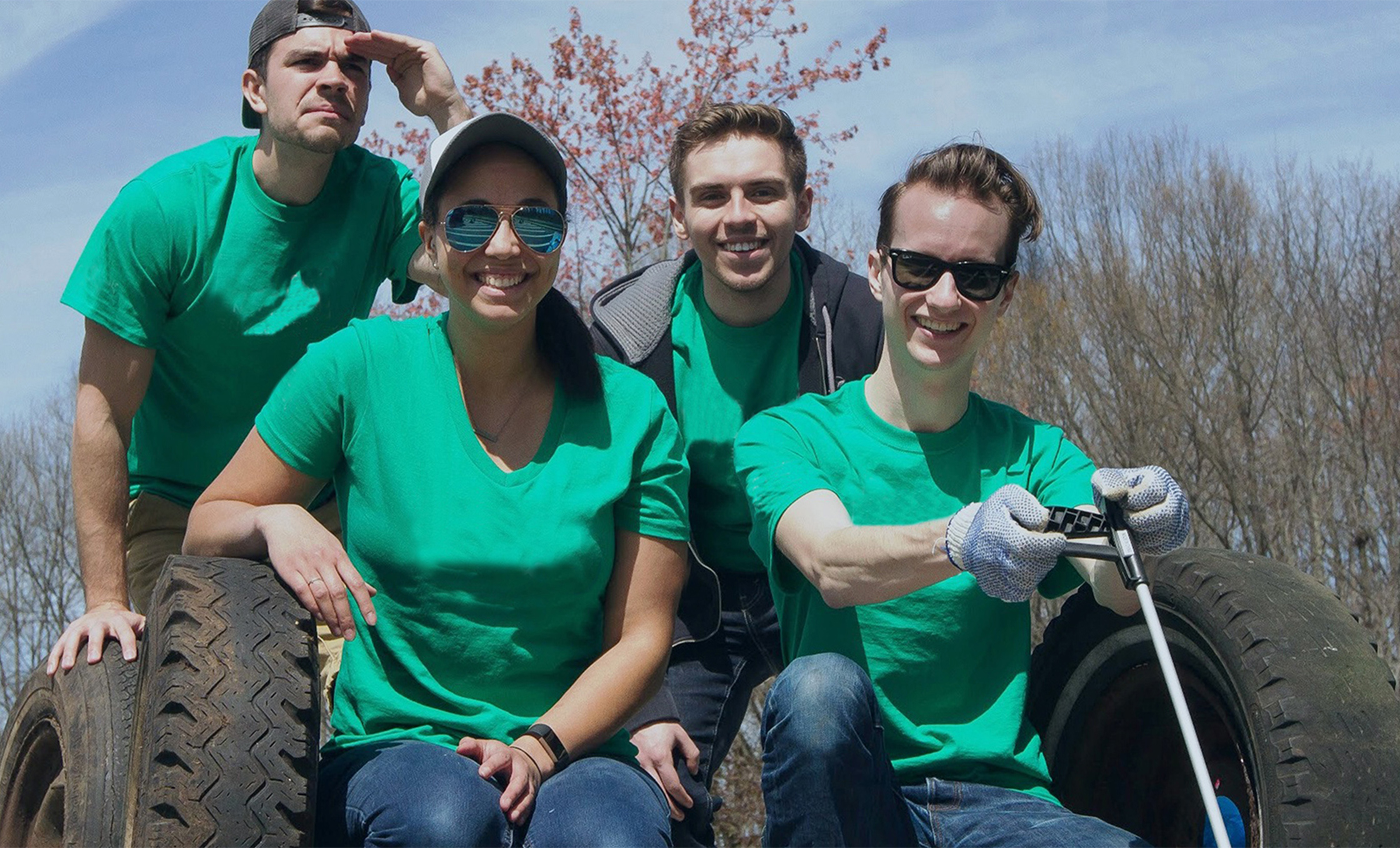 a group of people in green shirts