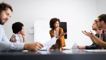 A group of people speaking around a table