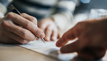 A person signing papers