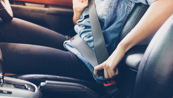 A person buckling their seatbelt