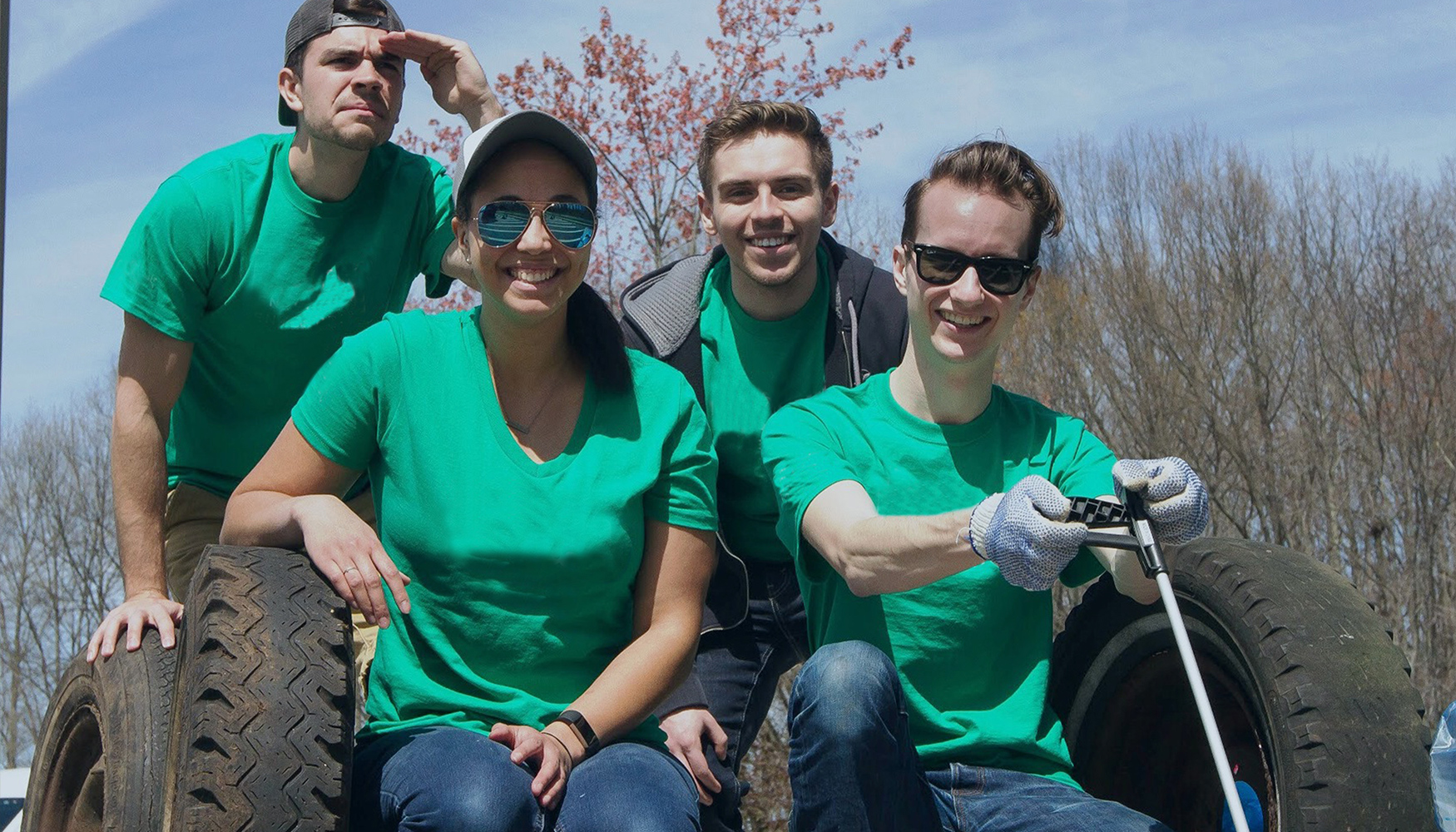 a group of people in green shirts