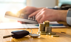 Stacks of coins and a set of car keys