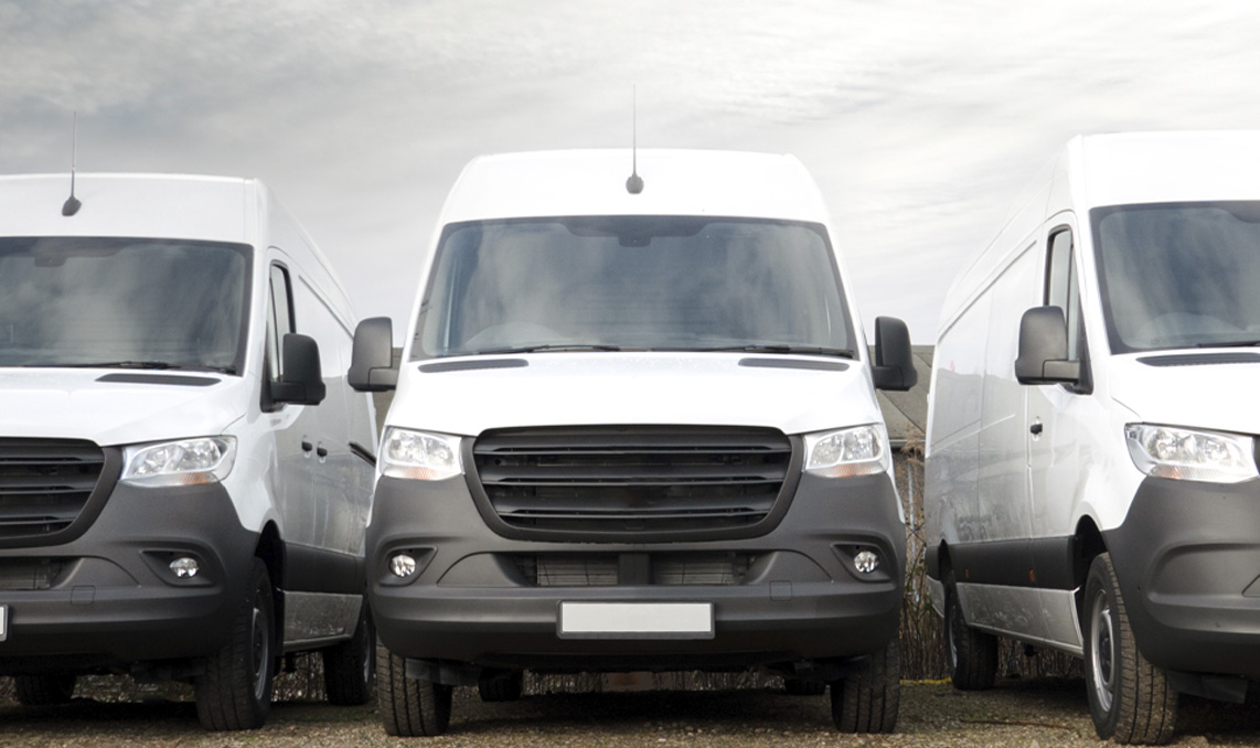 A line of white cargo vans