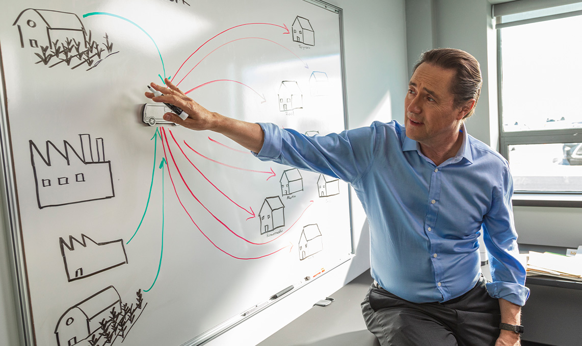 a man pointing at a whiteboard