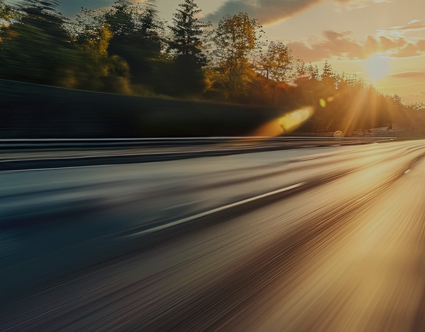 a blurry road with trees and sun