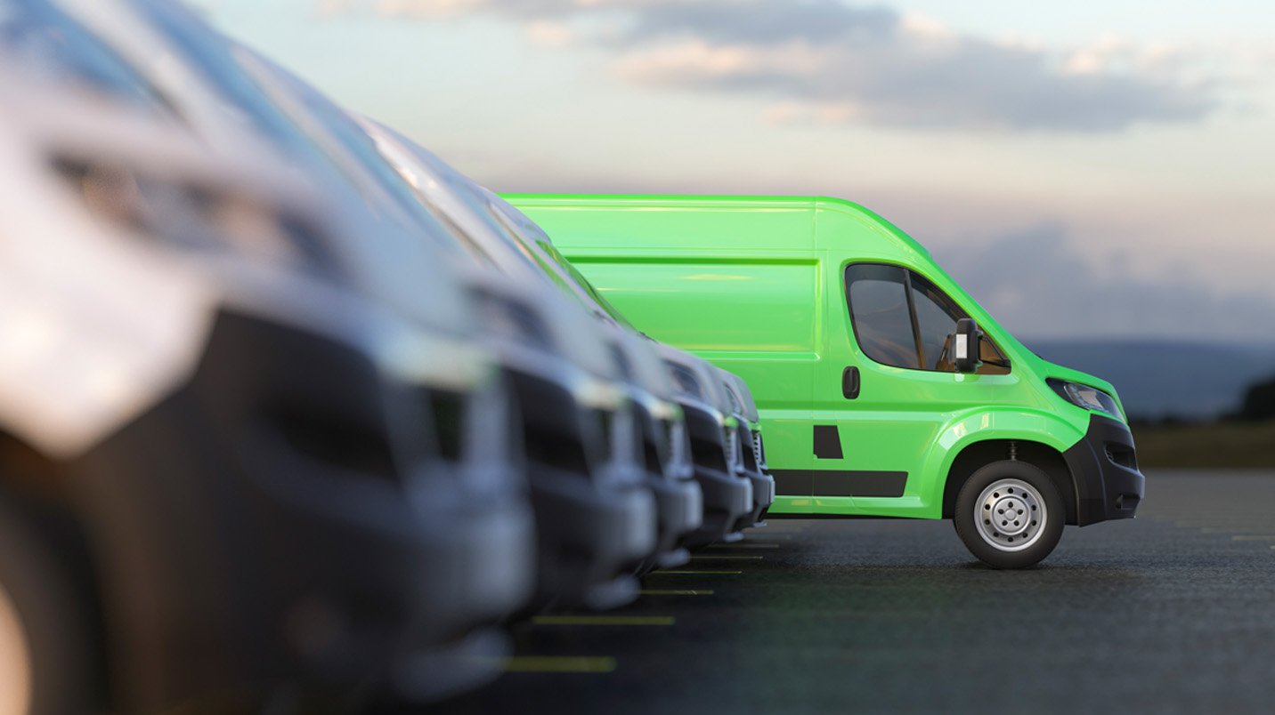 a green van parked in a row