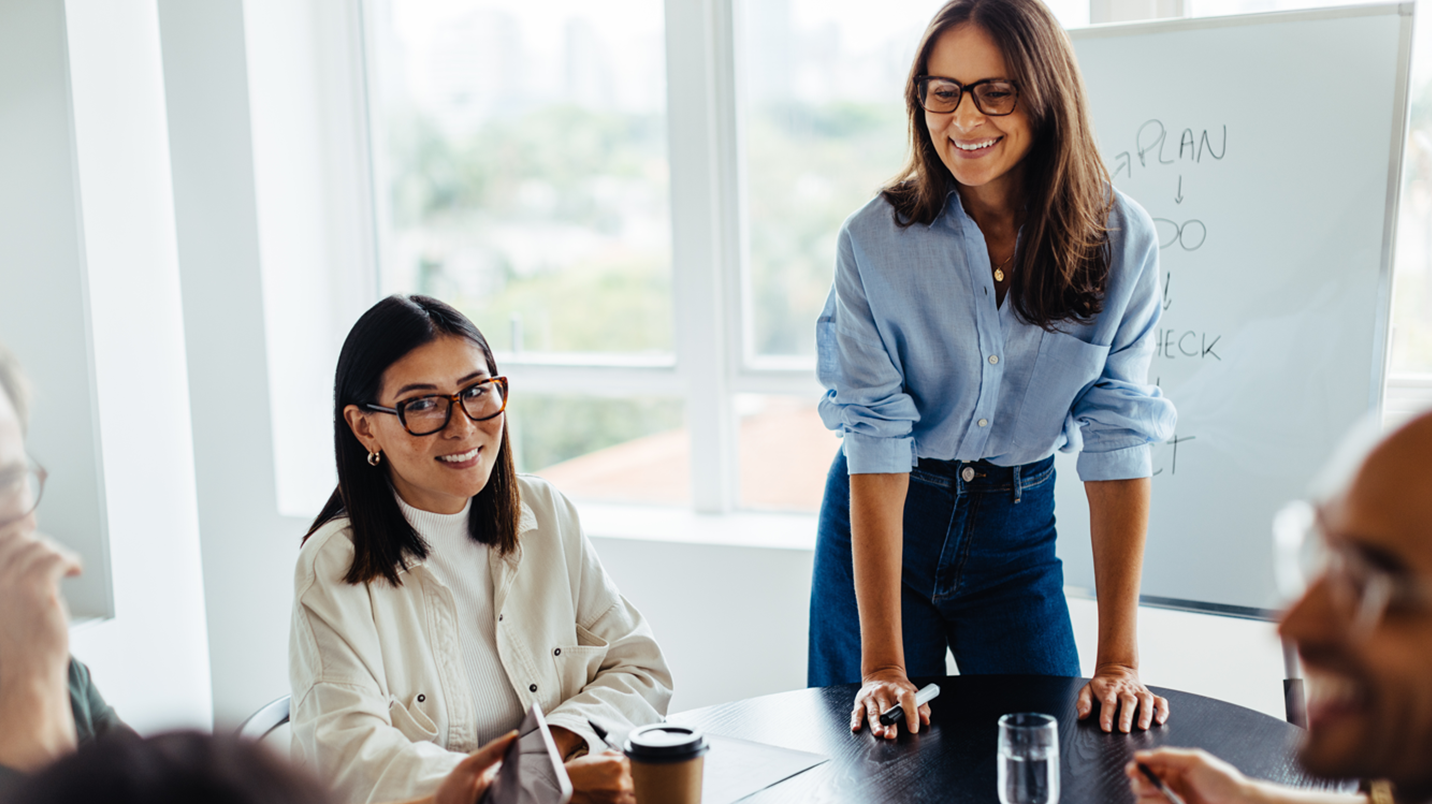 a group of women smiling at a table