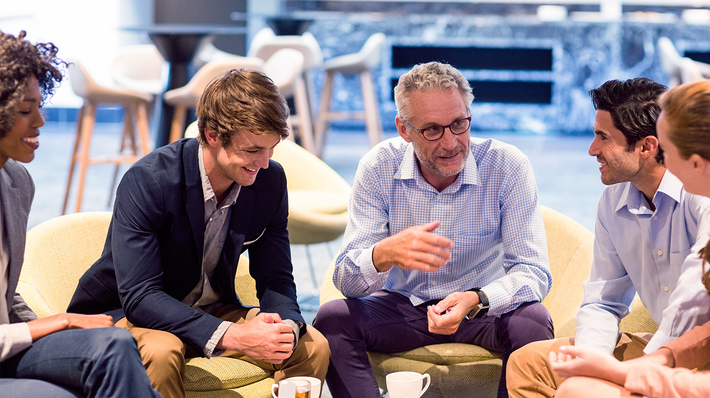 a group of men sitting in chairs
