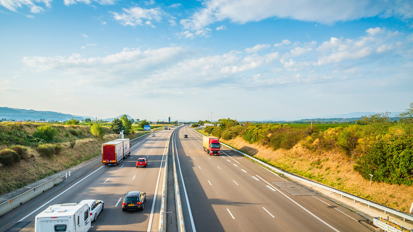a highway with cars and trucks on it