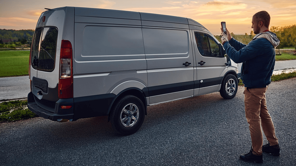a person taking a picture of a van