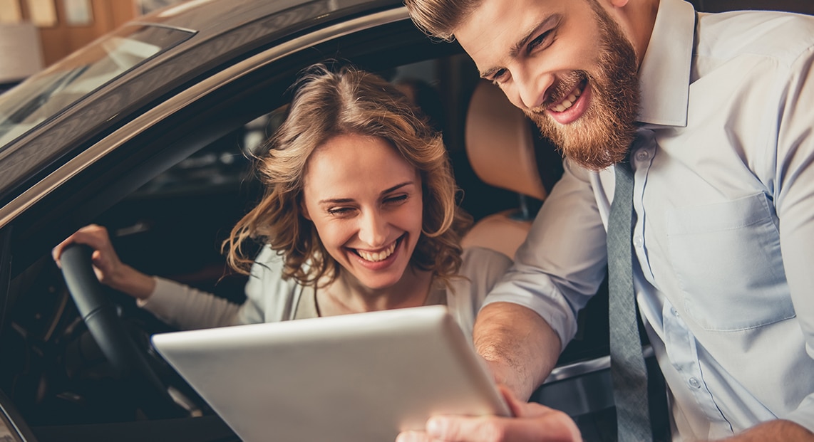 a man and woman looking at a tablet