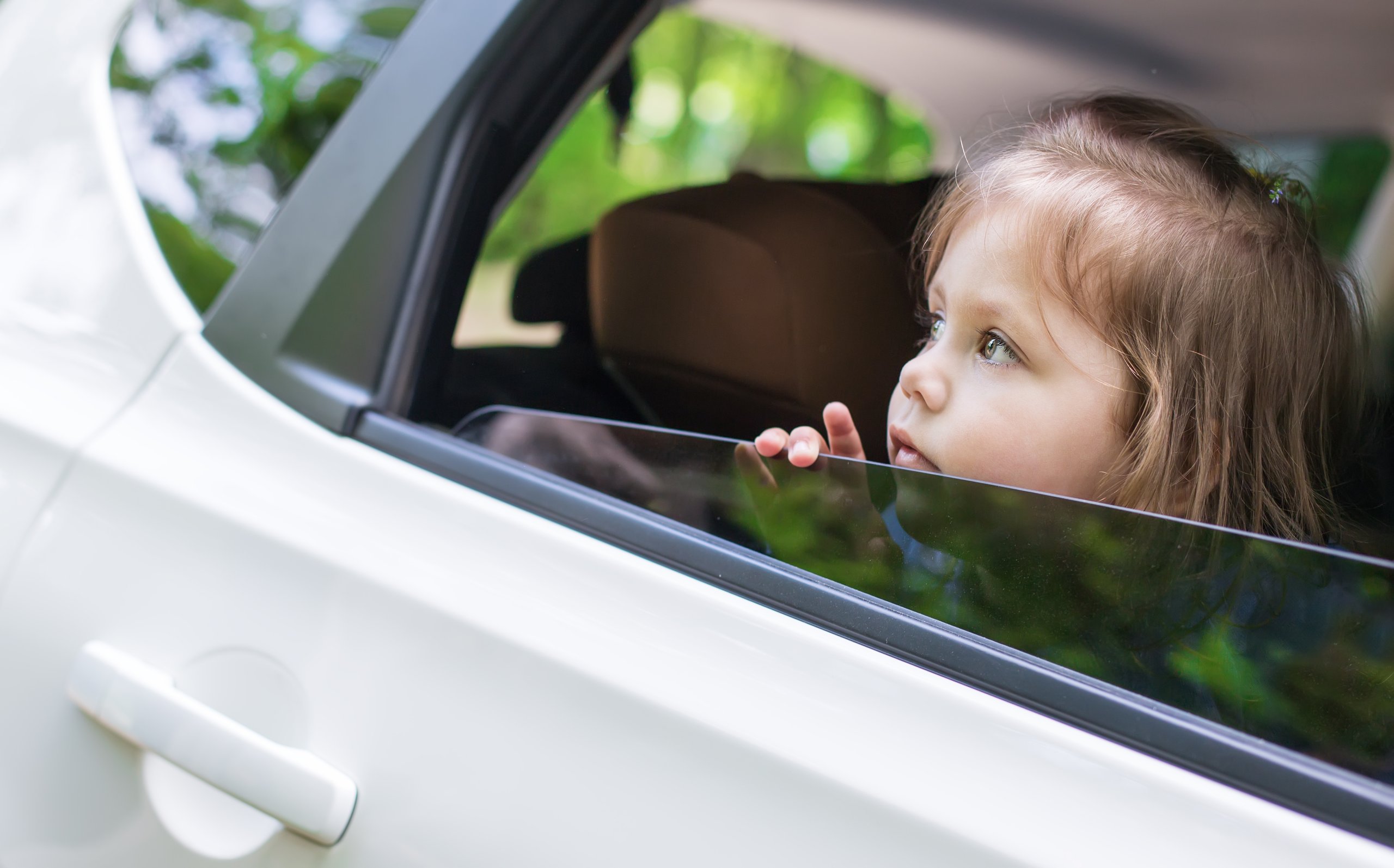 a child looking out of a car window