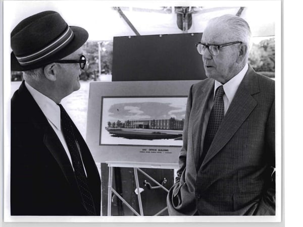 Black and white picture of 2 people talking