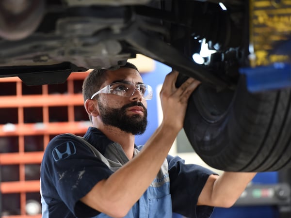 Man looking at the car tire