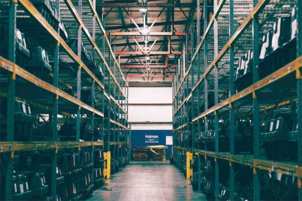 a warehouse with shelves and a blue sign
