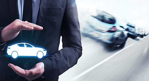 a man in a suit and tie holding a car icon
