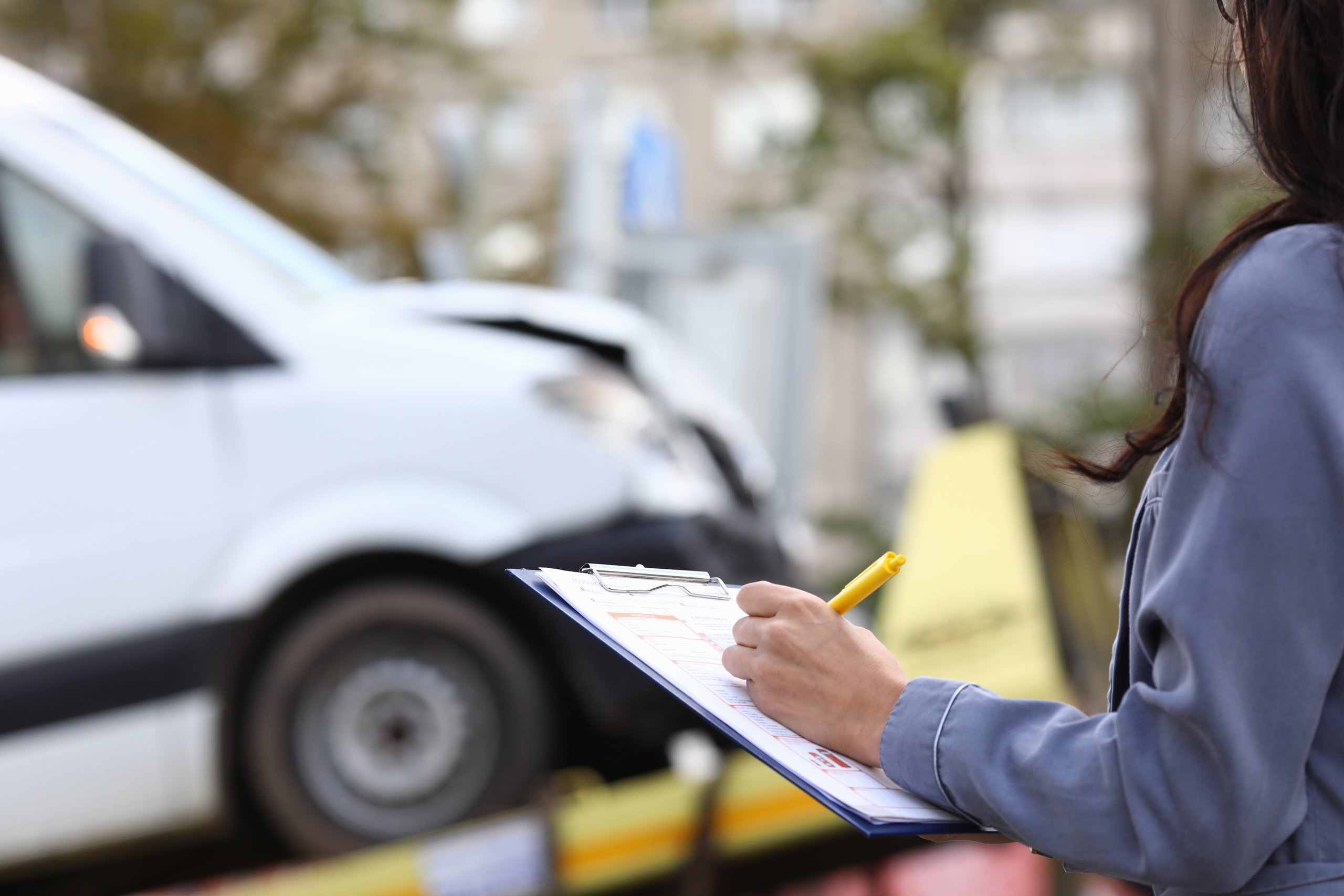 a woman holding a clipboard with a pen