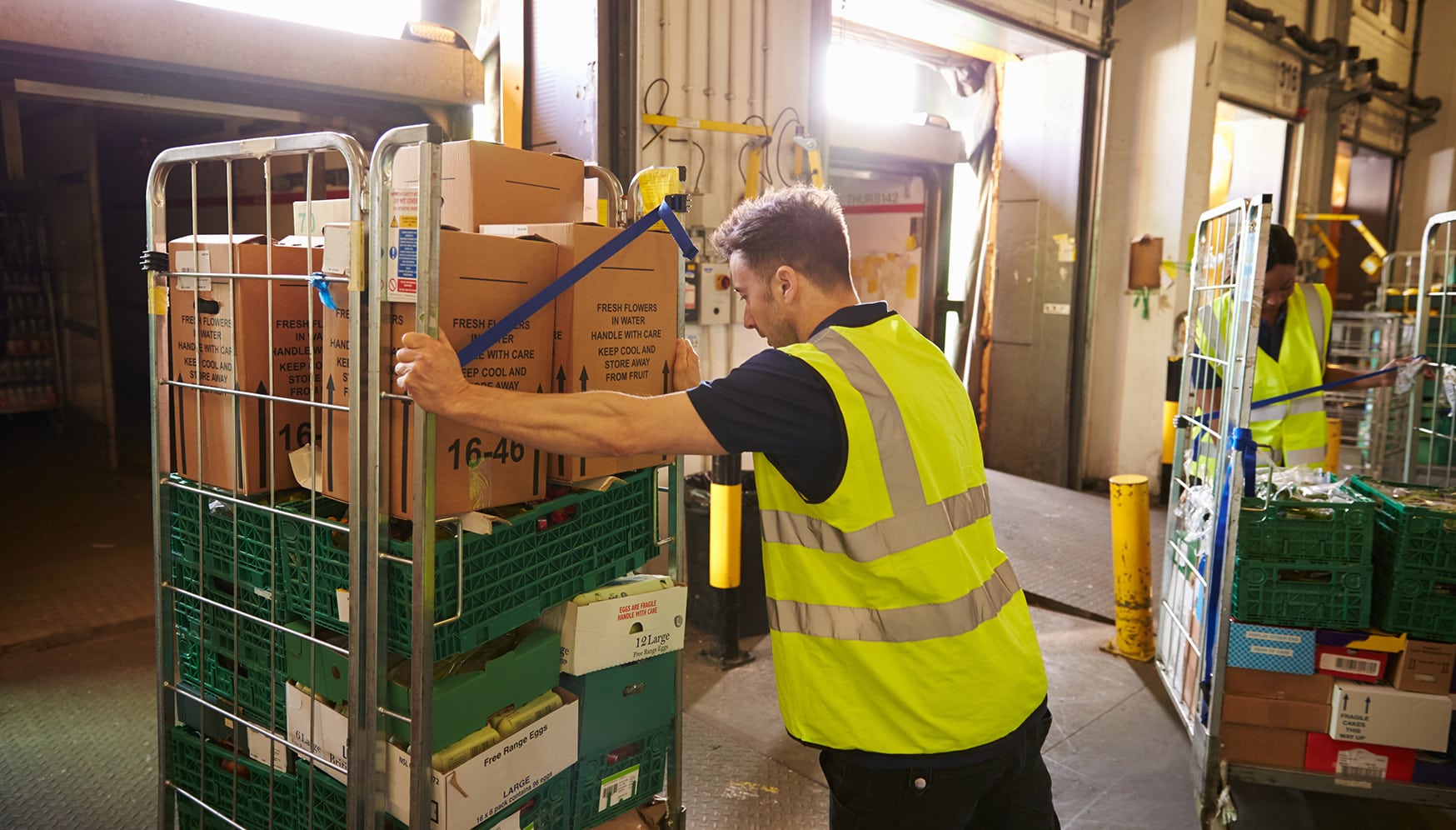 Man pushing a cart of boxes
