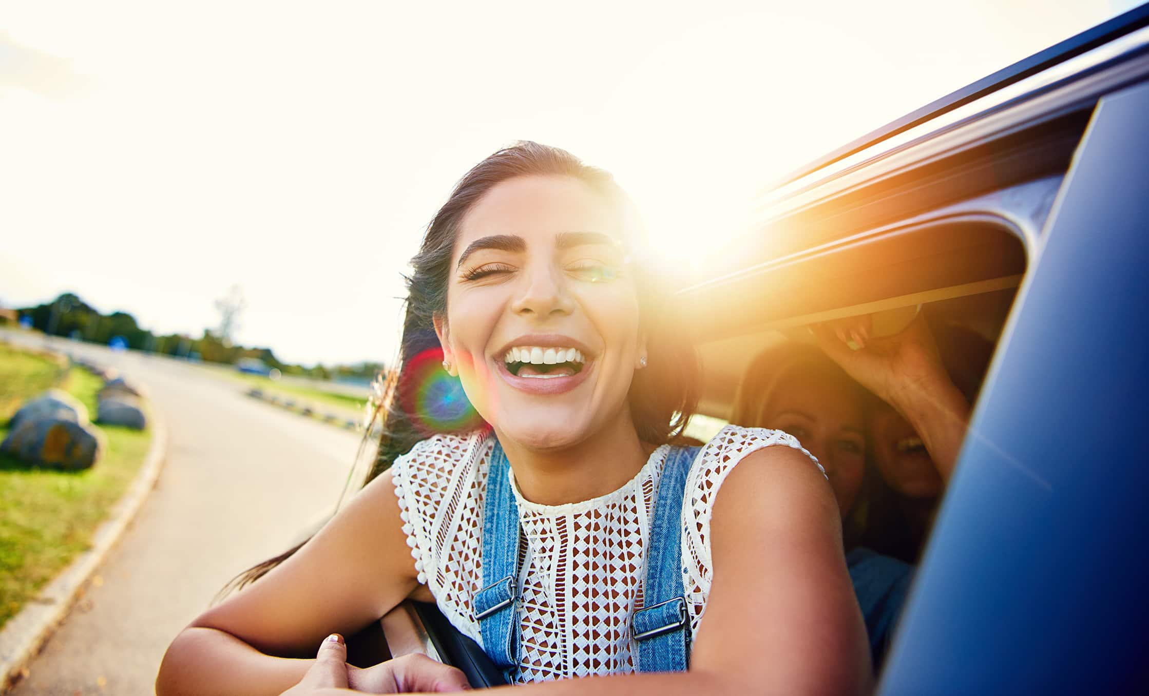 a woman smiling in a car