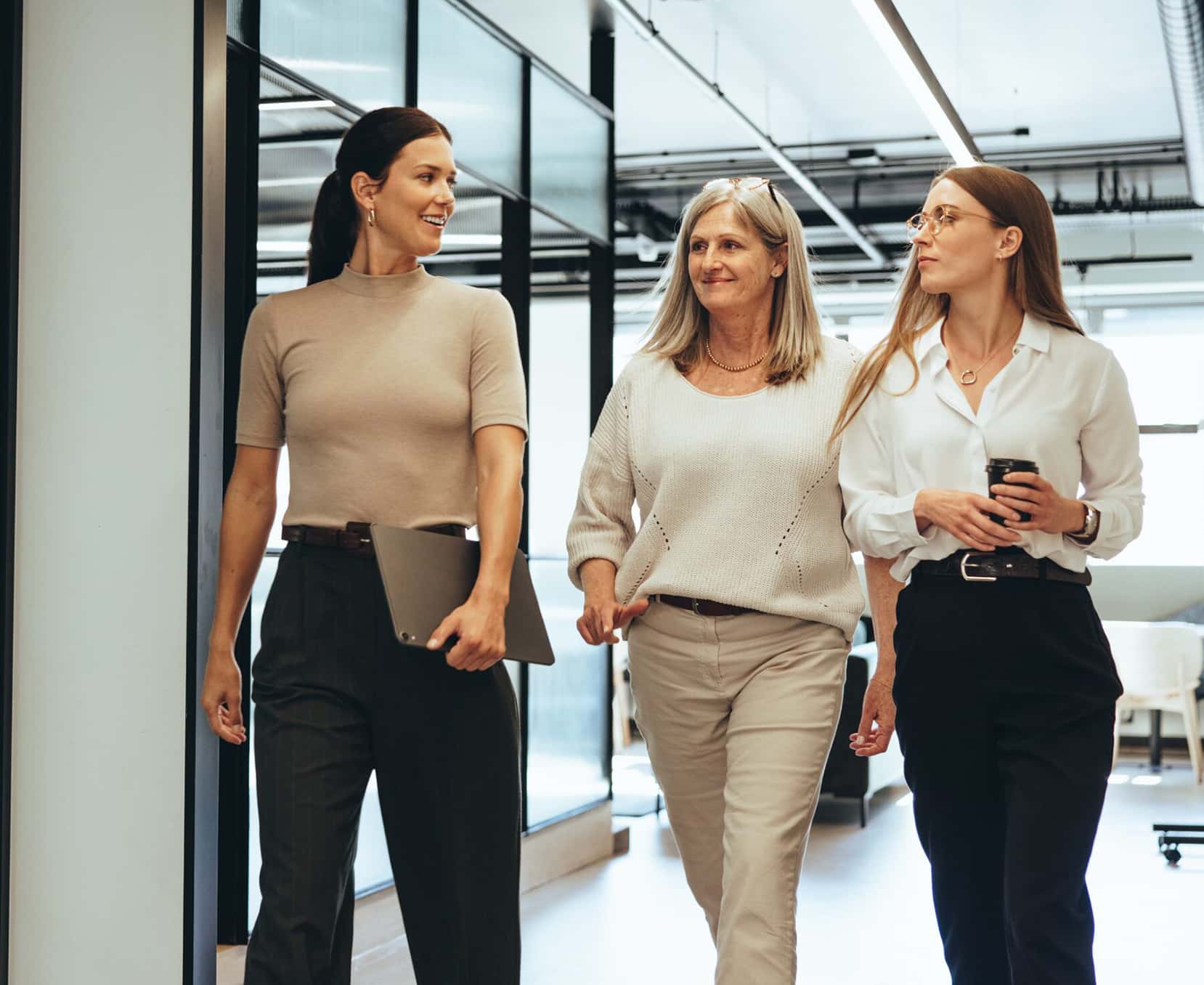 a group of women walking in a hallway