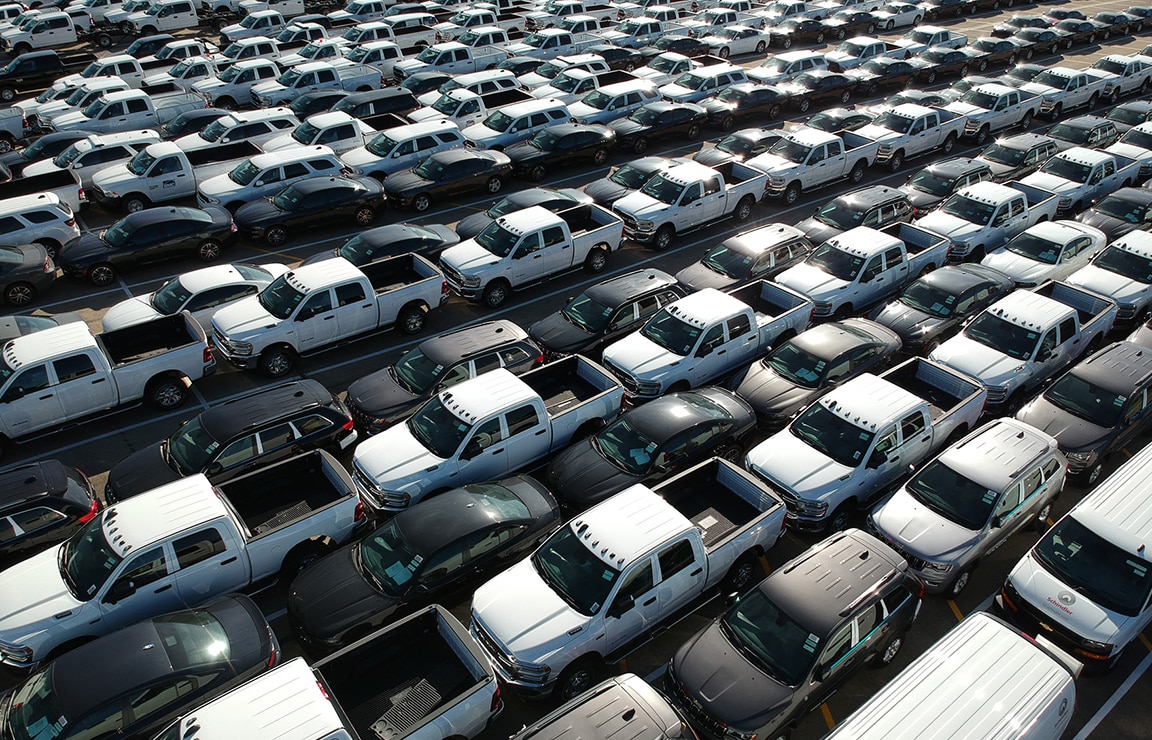 a large group of cars parked in a parking lot