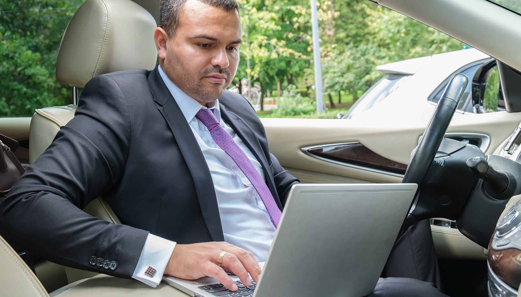 a man in a suit and tie working on a laptop