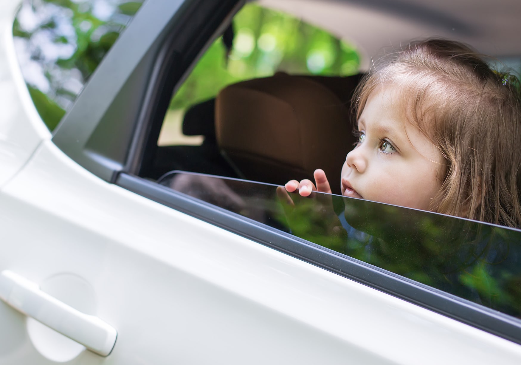 a child looking out of a car window
