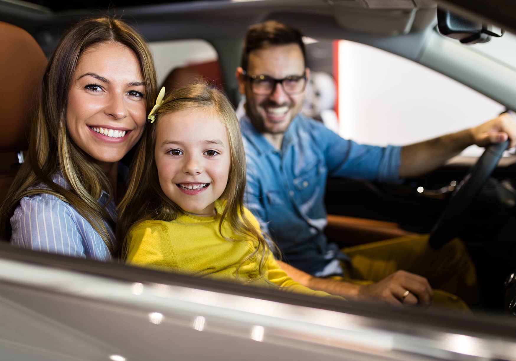 a family sitting in a car