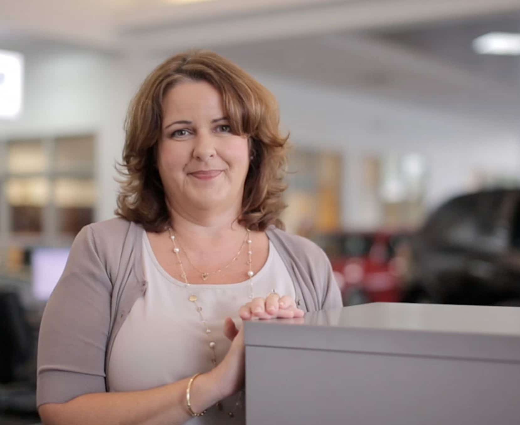 a woman leaning on a desk